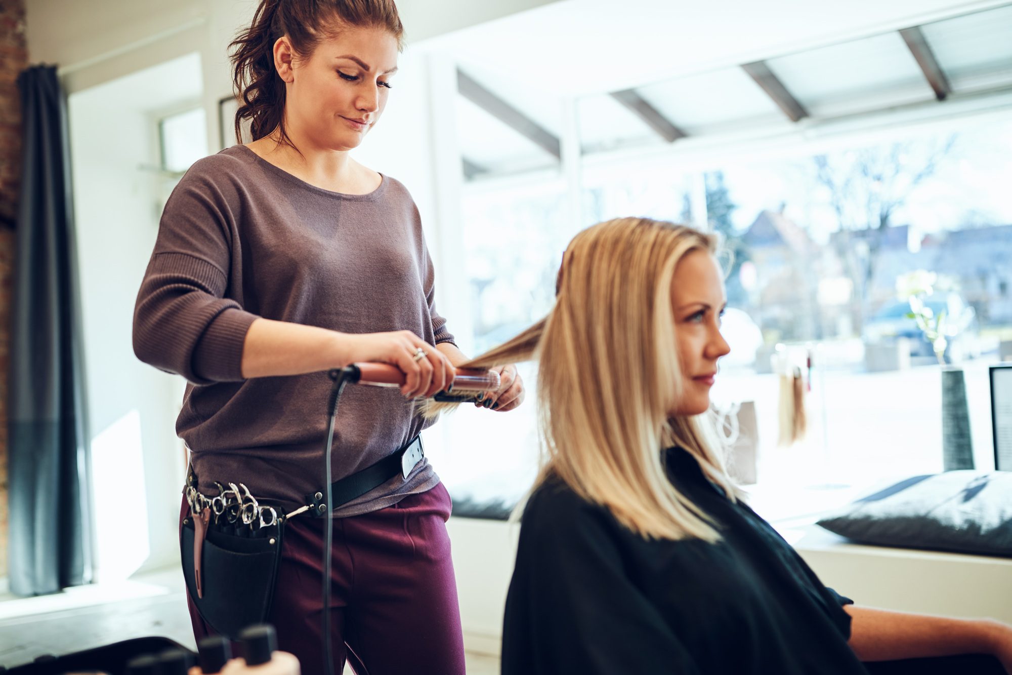 hairdresser-straightening-a-female-client